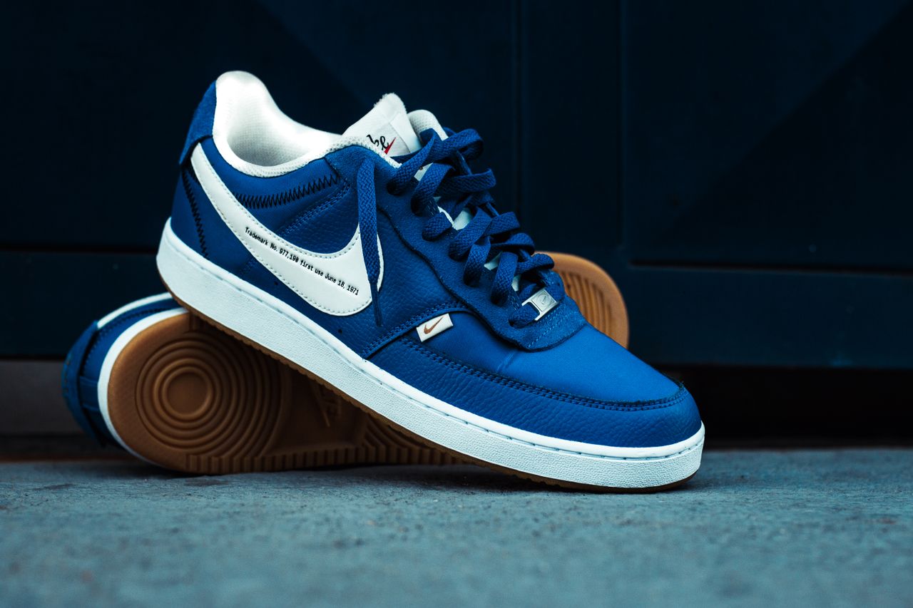 The Art of Drawing Readers In: Your attractive post title goes here Close-up of blue sneakers on a concrete floor showcasing stylish design.