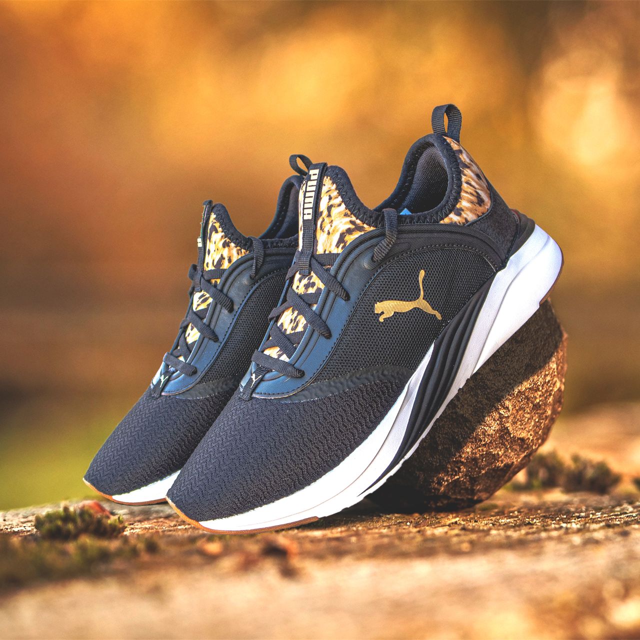 About Elegant Puma sneakers showcased on a rock, perfect for outdoor sports enthusiasts.